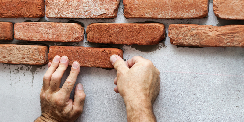Bricklayer installing brick veneer - Your Complete Guide to Installing Brick Veneer