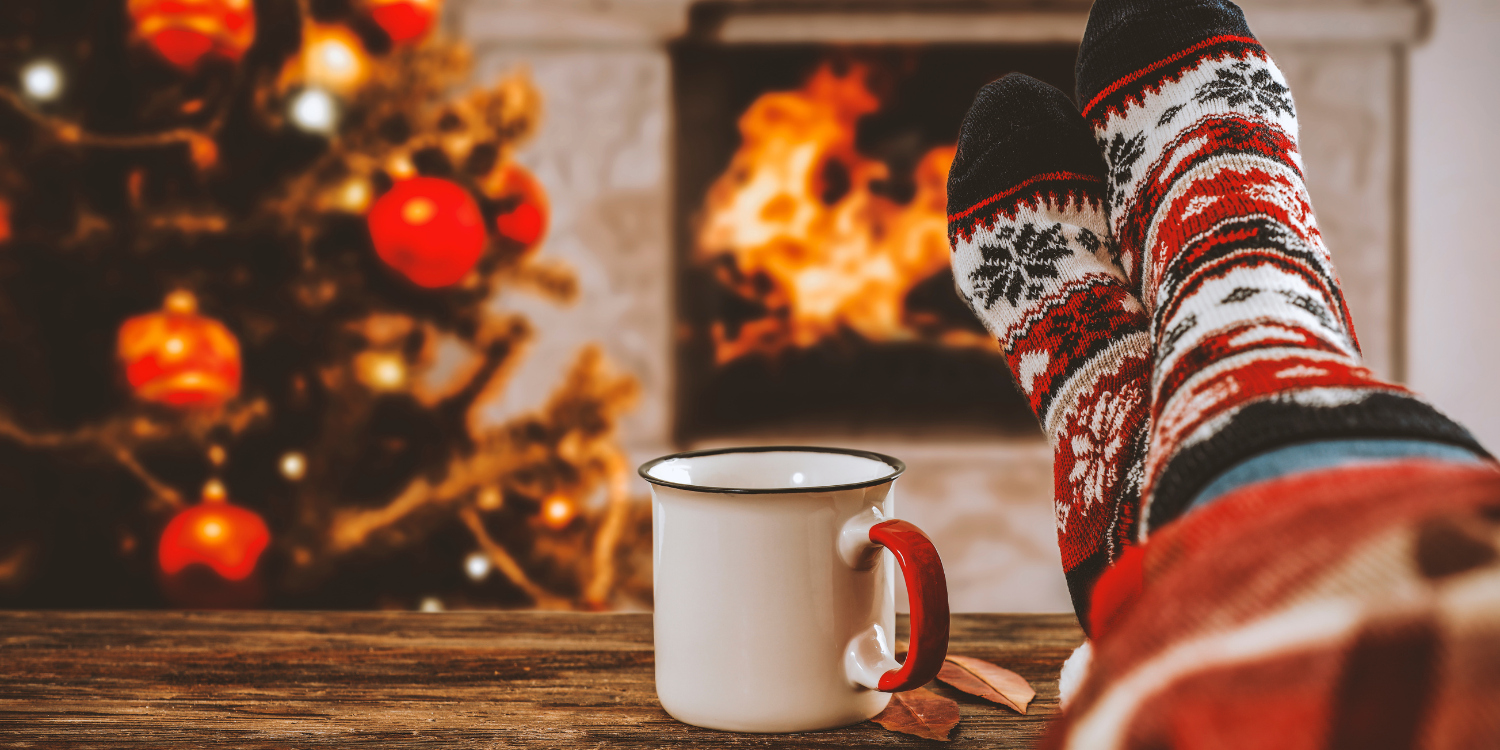 Women feet in front of wood burning fireplace at Christmas - Fireplace Safety During the Holidays (With Infographic) 